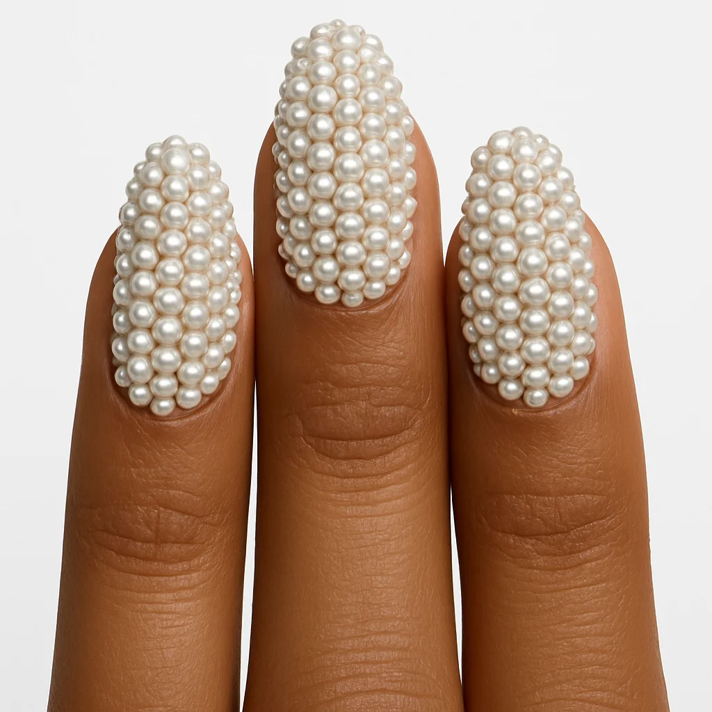 Full coverage pearl mosaic nails edge to edge on blush pink base on warm brown skin clean studio — pearl nail 2026