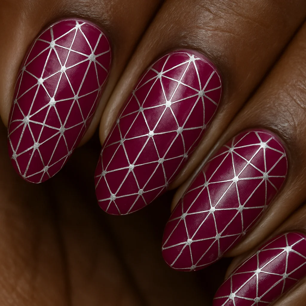 Deep fuchsia nails with silver triangle web pattern on dark brown skin — geometric pink nail art 2026