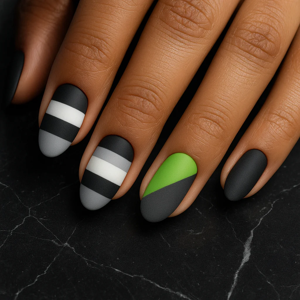 Short almond nails in agender Pride flag black white grey and lime green design on medium olive skin on black marble — agender pride nail 2026
